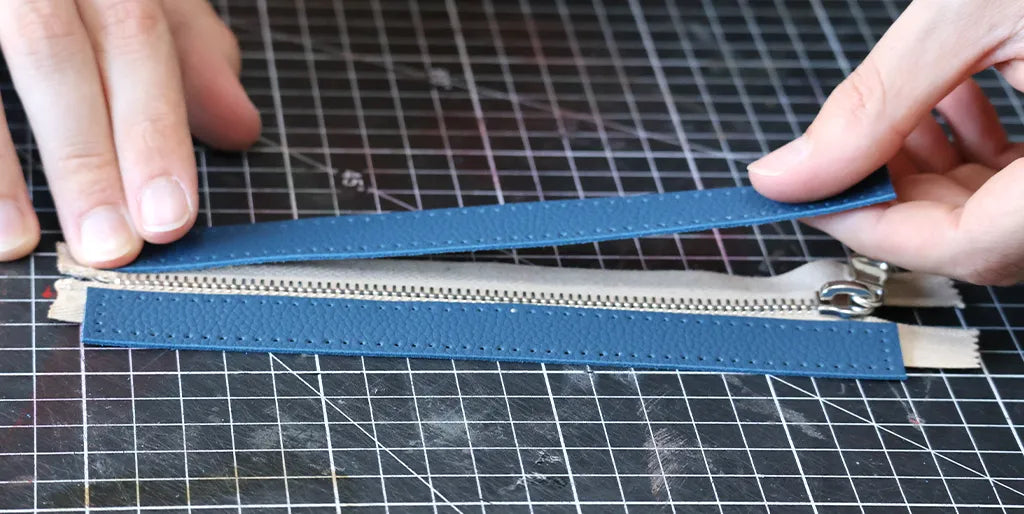 Glue the leather strip to the zipper